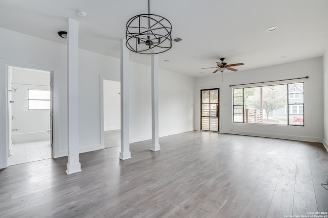 unfurnished living room featuring ceiling fan and light wood-type flooring