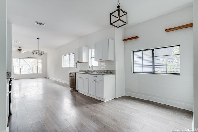 kitchen featuring light stone countertops, ceiling fan, pendant lighting, white cabinets, and light wood-type flooring