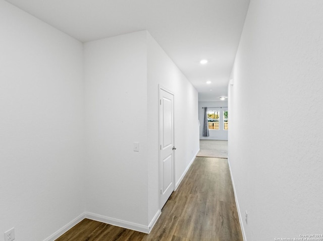 hall with wood-type flooring and french doors