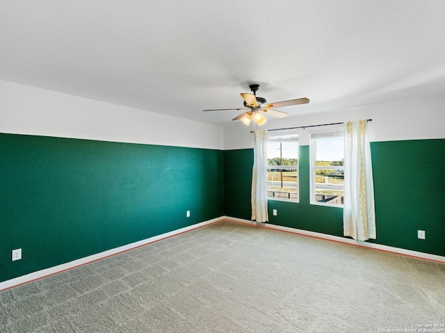 empty room featuring carpet flooring and ceiling fan