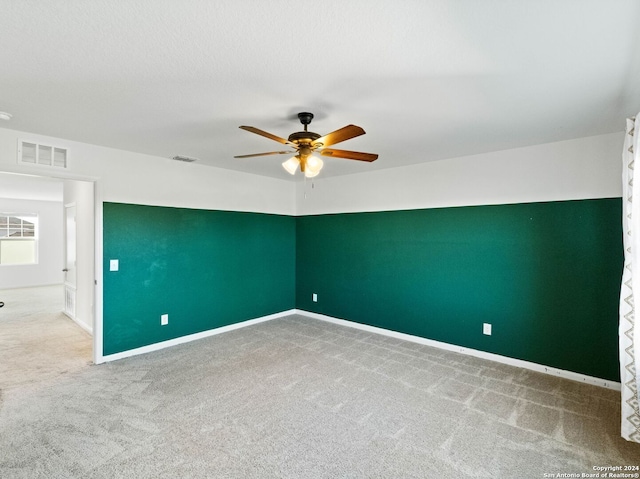 carpeted empty room with ceiling fan