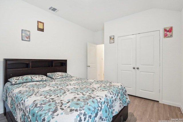 bedroom with a closet and light hardwood / wood-style flooring