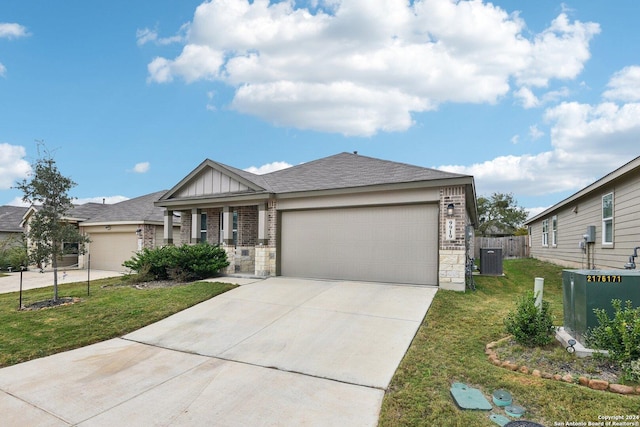 view of front of home with a garage, a front lawn, and cooling unit