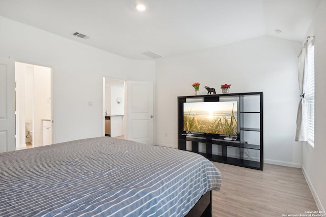 bedroom featuring vaulted ceiling and hardwood / wood-style flooring