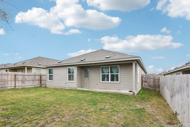 rear view of house featuring a yard