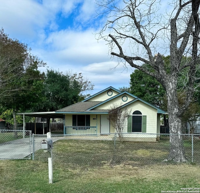 view of front facade with a front yard, a carport, and covered porch