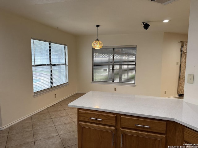 kitchen featuring light tile patterned floors and hanging light fixtures