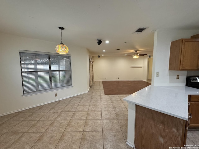 kitchen with pendant lighting, ceiling fan, light tile patterned flooring, and kitchen peninsula