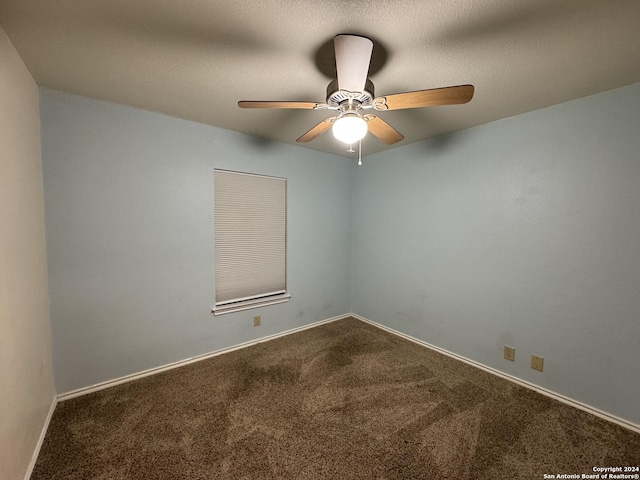 carpeted spare room featuring ceiling fan and a textured ceiling