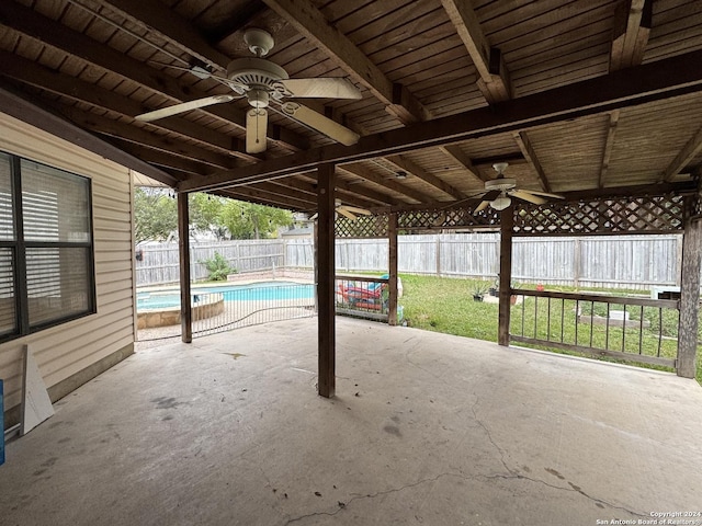 view of patio / terrace with a fenced in pool and ceiling fan