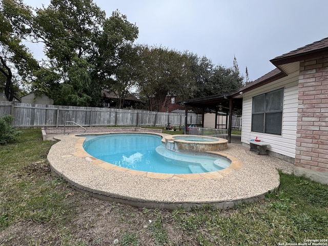 view of pool with an in ground hot tub