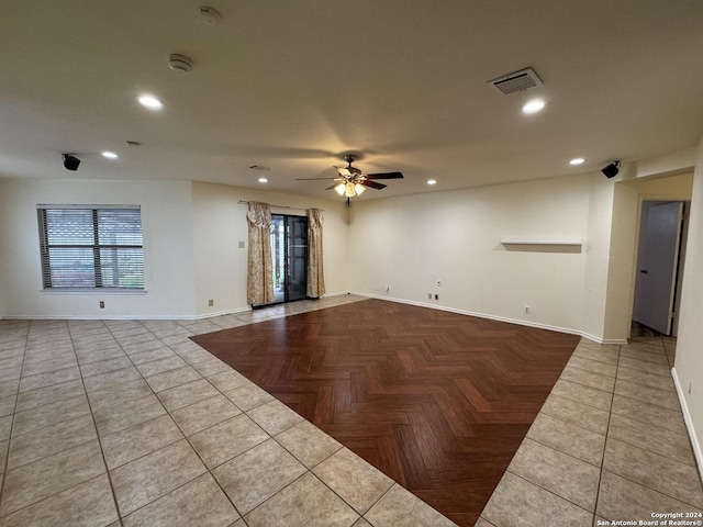 unfurnished room featuring ceiling fan, light tile patterned floors, and a healthy amount of sunlight