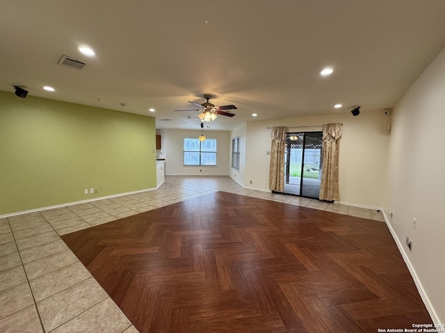 unfurnished living room with tile patterned floors and ceiling fan