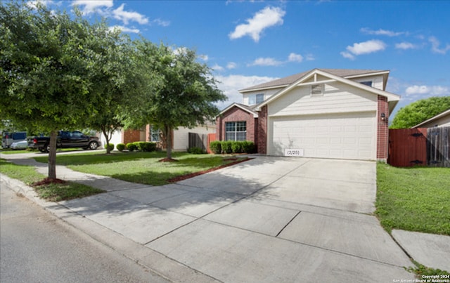 view of front of property with a garage and a front yard