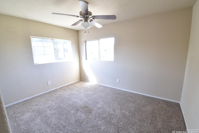 spare room featuring carpet floors and ceiling fan