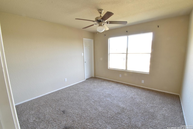 unfurnished room with ceiling fan and carpet floors