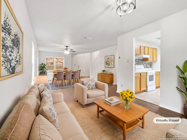 living room featuring light hardwood / wood-style flooring and ceiling fan