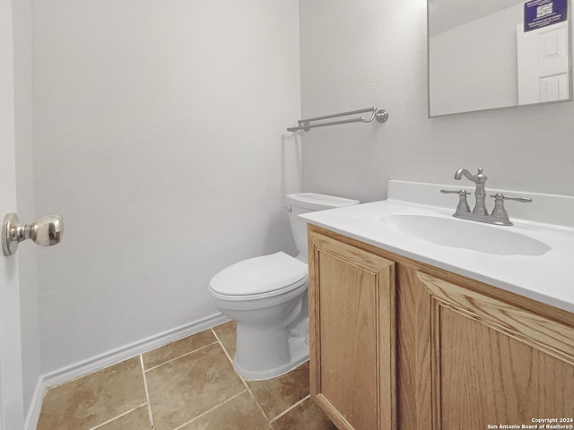 bathroom with tile patterned flooring, vanity, and toilet