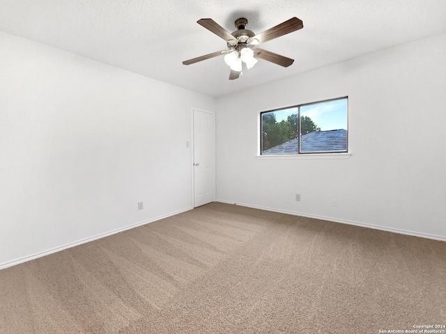 carpeted spare room with ceiling fan and a textured ceiling