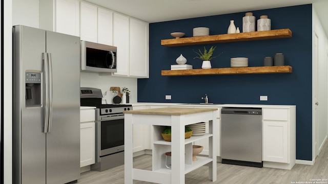 kitchen featuring white cabinets, light hardwood / wood-style floors, sink, and appliances with stainless steel finishes