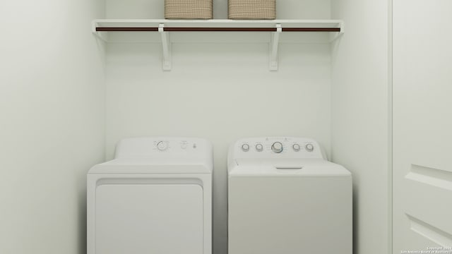 clothes washing area with washer and clothes dryer