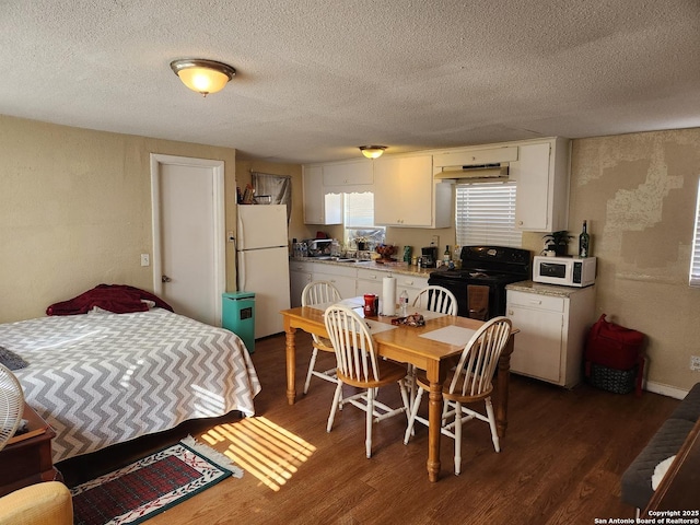 interior space featuring dark hardwood / wood-style flooring, white appliances, and white cabinets