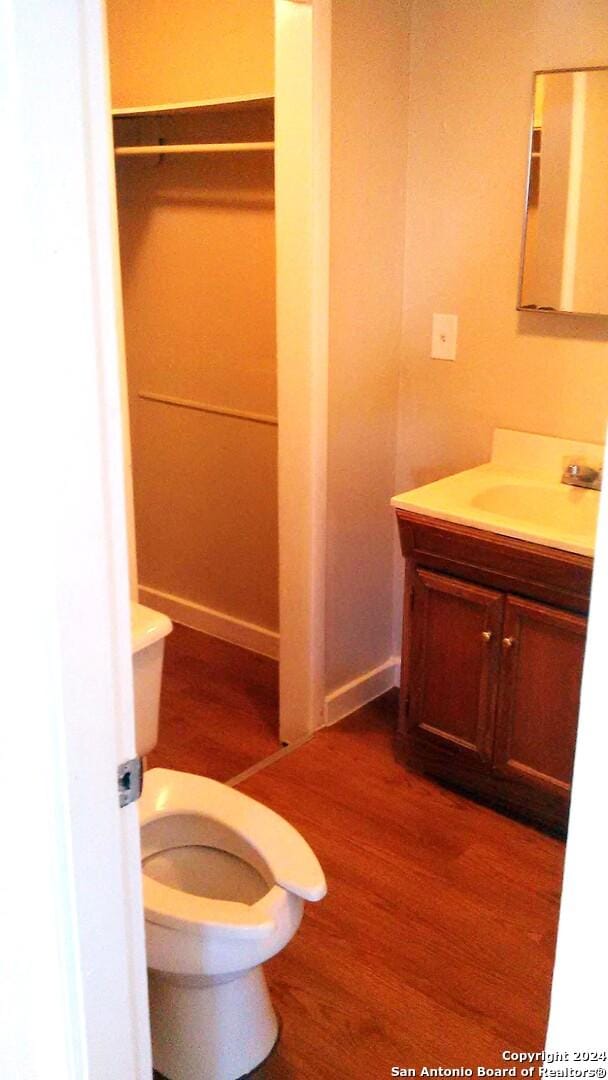 bathroom featuring hardwood / wood-style floors, vanity, and toilet