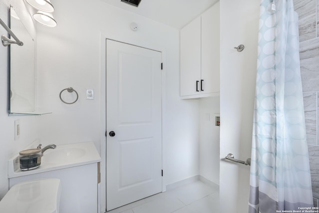 bathroom featuring tile patterned flooring and vanity