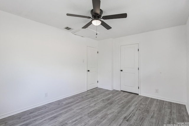 spare room with light hardwood / wood-style floors and ceiling fan