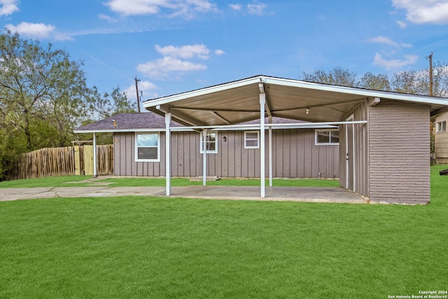 rear view of property featuring a lawn