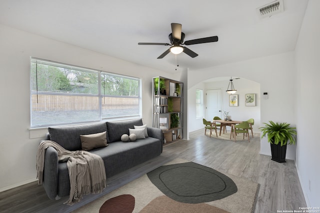 living room with hardwood / wood-style flooring and ceiling fan