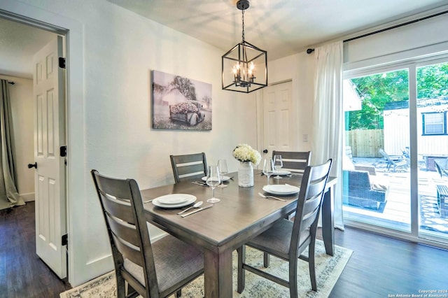 dining room with dark hardwood / wood-style floors and a notable chandelier