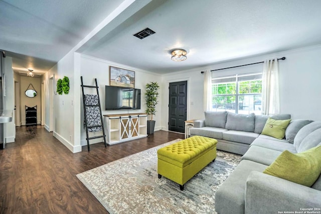 living room featuring dark hardwood / wood-style floors, ceiling fan, and ornamental molding