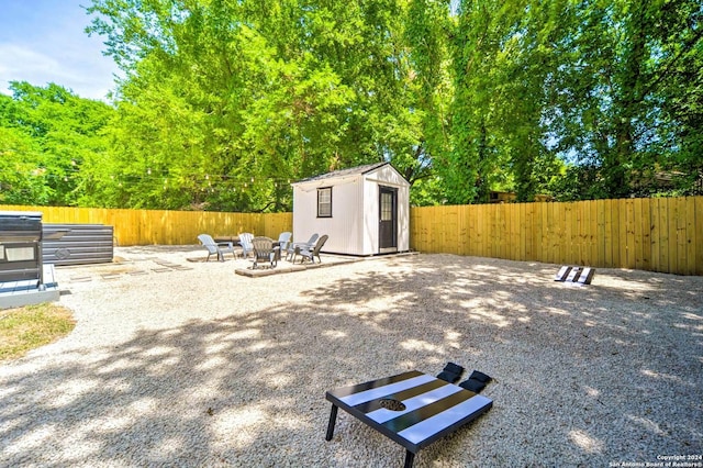 view of patio featuring a fire pit and a storage shed