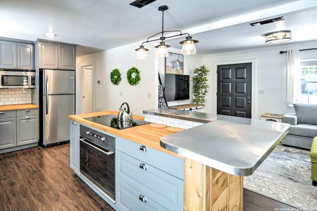 kitchen with tasteful backsplash, wooden counters, dark hardwood / wood-style floors, gray cabinets, and black appliances