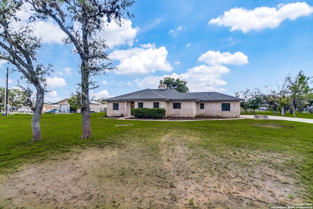 ranch-style home with a front lawn