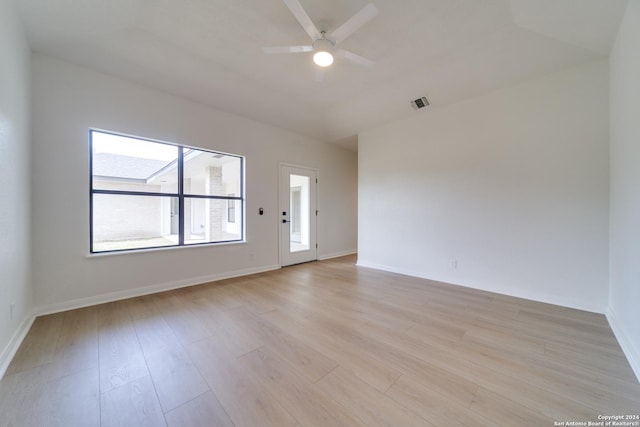 empty room featuring ceiling fan and light hardwood / wood-style flooring