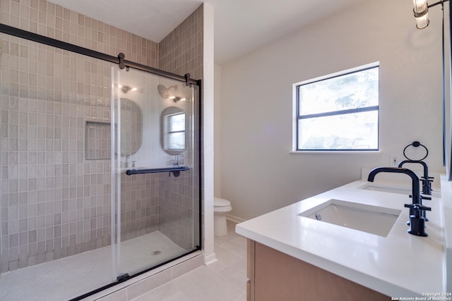 bathroom with toilet, vanity, tile patterned floors, and walk in shower