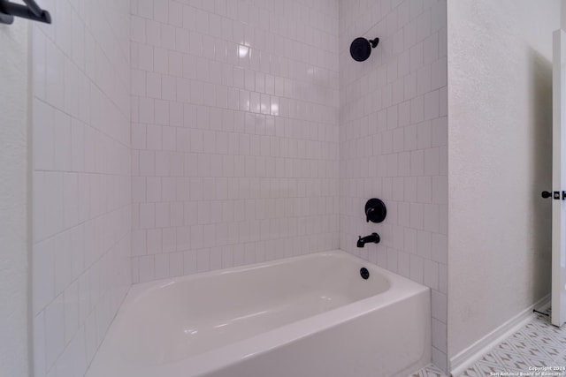 bathroom with tile patterned floors and tiled shower / bath