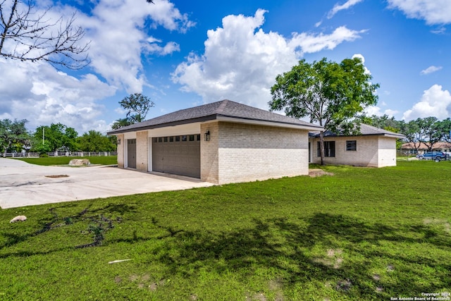 view of side of home with a yard and a garage