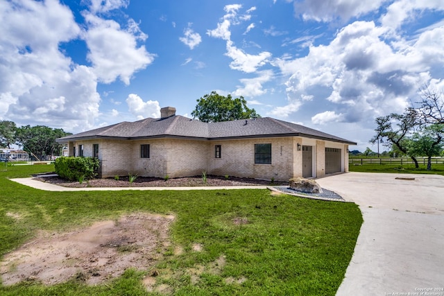 exterior space with a garage and a front lawn