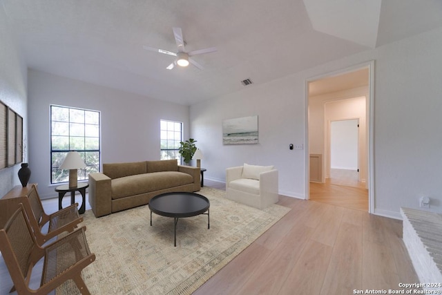 living room with light hardwood / wood-style flooring and ceiling fan