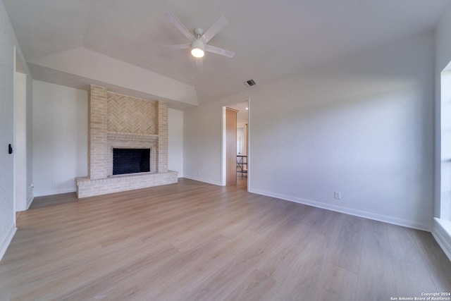 unfurnished living room with a fireplace, ceiling fan, and light hardwood / wood-style flooring