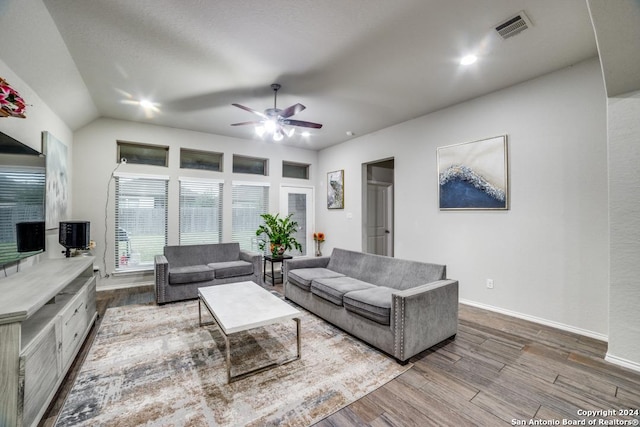 living room featuring ceiling fan, wood-type flooring, and lofted ceiling