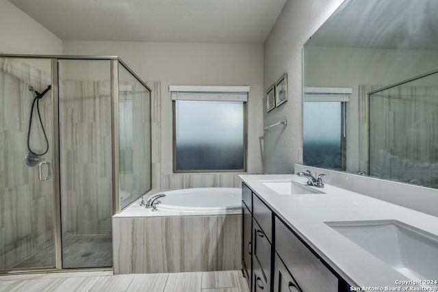 bathroom featuring separate shower and tub and vanity