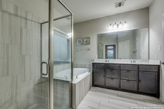 bathroom featuring vanity and separate shower and tub