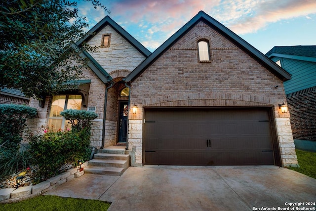 french country home with a garage