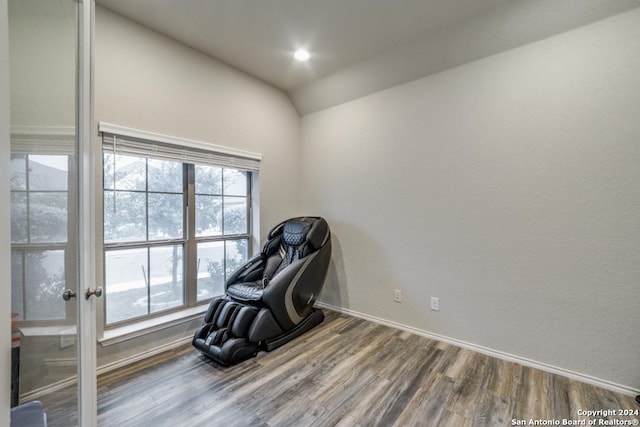 sitting room with hardwood / wood-style flooring and lofted ceiling