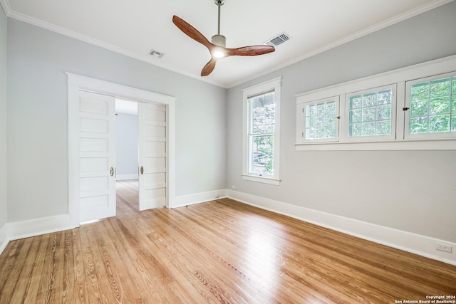 unfurnished room featuring ceiling fan, ornamental molding, and light wood-type flooring