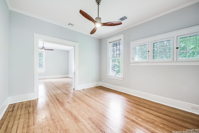 empty room featuring crown molding, ceiling fan, and light hardwood / wood-style floors